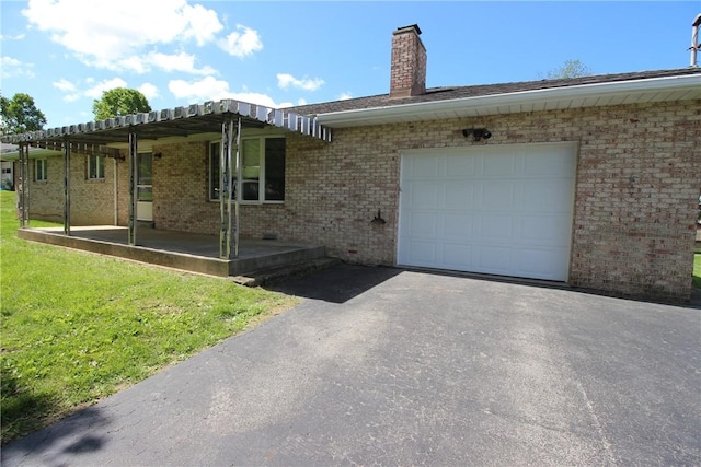 2224 Park Ave, Manor Twp, PA 16226 - view of front facade featuring brick siding, a chimney, asphalt driveway, an attached garage, and a front yard