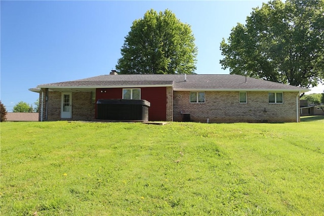 2224 Park Ave, Manor Twp, PA 16226 - rear view of house featuring a hot tub, a yard, and brick siding
