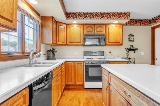 113 Sunburst Ct, Center Twp But, PA 16001 - kitchen with black appliances, a sink, light wood finished floors, light countertops, and brown cabinetry