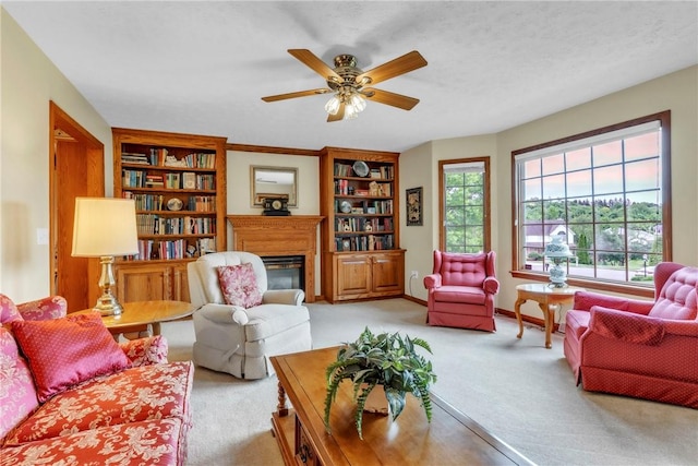 113 Sunburst Ct, Center Twp But, PA 16001 - living area with light colored carpet, a glass covered fireplace, built in shelves, a ceiling fan, and baseboards