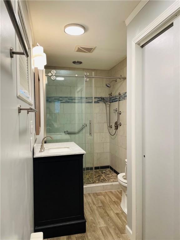192 W Lincoln St, Waynsbrg/Frankln Twp, PA 15370 - bathroom with toilet, wood finished floors, a stall shower, and vanity