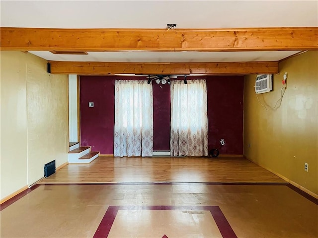 192 W Lincoln St, Waynsbrg/Frankln Twp, PA 15370 - unfurnished room with beamed ceiling, a wall mounted AC, stairs, baseboards, and wood finished floors