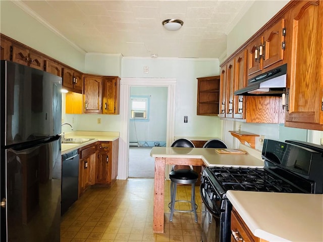 192 W Lincoln St, Waynsbrg/Frankln Twp, PA 15370 - kitchen featuring black appliances, under cabinet range hood, a sink, light countertops, and a kitchen breakfast bar