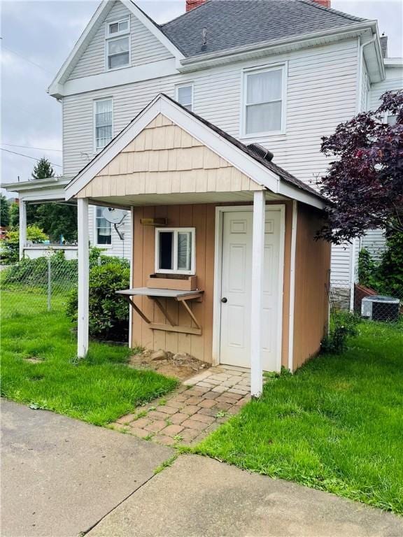 192 W Lincoln St, Waynsbrg/Frankln Twp, PA 15370 - view of front of property featuring a chimney, roof with shingles, board and batten siding, and central air condition unit