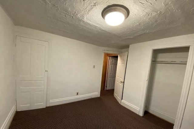 314 Lowell Unit 1/2, Vandergrift Wml, PA 15690 - unfurnished bedroom with baseboards, dark carpet, and a closet