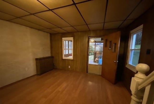314 Lowell Unit 1/2, Vandergrift Wml, PA 15690 - unfurnished room featuring radiator, light wood-style floors, and a drop ceiling