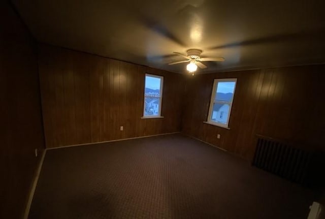 314 Lowell Unit 1/2, Vandergrift Wml, PA 15690 - carpeted spare room featuring ceiling fan, plenty of natural light, wooden walls, and radiator