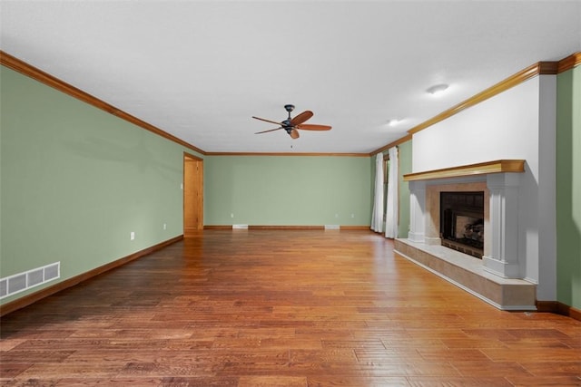 100 Firethorn Rd, Economy, PA 15005 - unfurnished living room with ornamental molding, ceiling fan, wood finished floors, a fireplace with raised hearth, and baseboards
