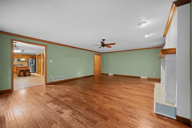100 Firethorn Rd, Economy, PA 15005 - unfurnished living room with ornamental molding, ceiling fan, baseboards, light wood finished floors, and a chandelier