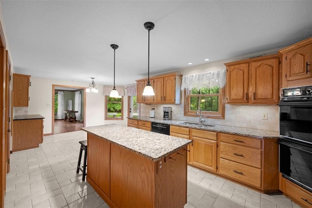 100 Firethorn Rd, Economy, PA 15005 - kitchen featuring black appliances, a sink, decorative backsplash, a center island, and plenty of natural light