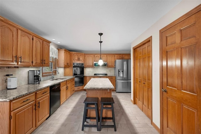 100 Firethorn Rd, Economy, PA 15005 - kitchen with black appliances, a sink, tasteful backsplash, a center island, and light stone counters