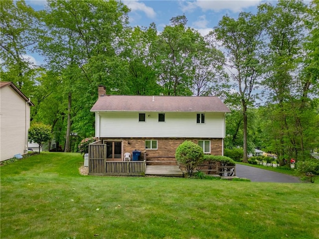 454 Cherokee Dr, Center Twp But, PA 16001 - rear view of house featuring a chimney, brick siding, and a lawn