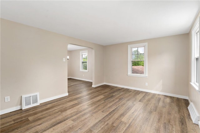 6225 Smithfield St, Elizabeth Twp/Boro, PA 15135 - spare room featuring arched walkways, wood finished floors, healthy amount of natural light, and baseboards