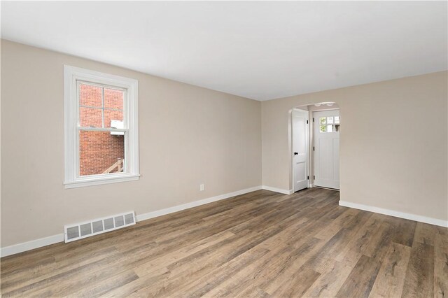 6225 Smithfield St, Elizabeth Twp/Boro, PA 15135 - empty room with arched walkways, wood finished floors, and baseboards