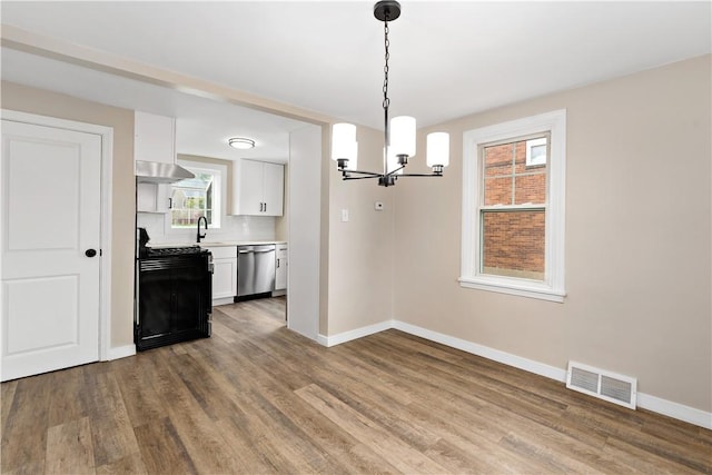 6225 Smithfield St, Elizabeth Twp/Boro, PA 15135 - kitchen with dishwasher, a chandelier, baseboards, white cabinetry, and wood finished floors
