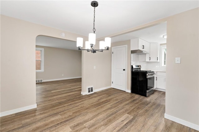6225 Smithfield St, Elizabeth Twp/Boro, PA 15135 - kitchen with stainless steel range with gas cooktop, a chandelier, white cabinets, wood finished floors, and baseboards