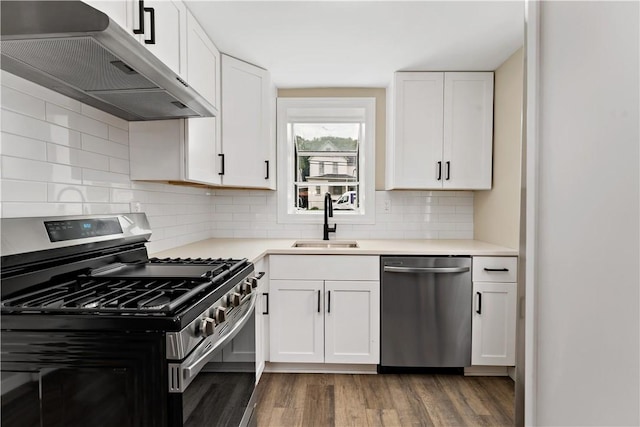 6225 Smithfield St, Elizabeth Twp/Boro, PA 15135 - kitchen with stainless steel appliances, wall chimney exhaust hood, a sink, and dark wood finished floors