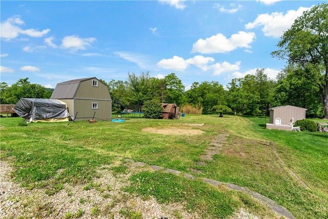 6225 Smithfield St, Elizabeth Twp/Boro, PA 15135 - view of grassy yard with a trampoline and view of wooded area
