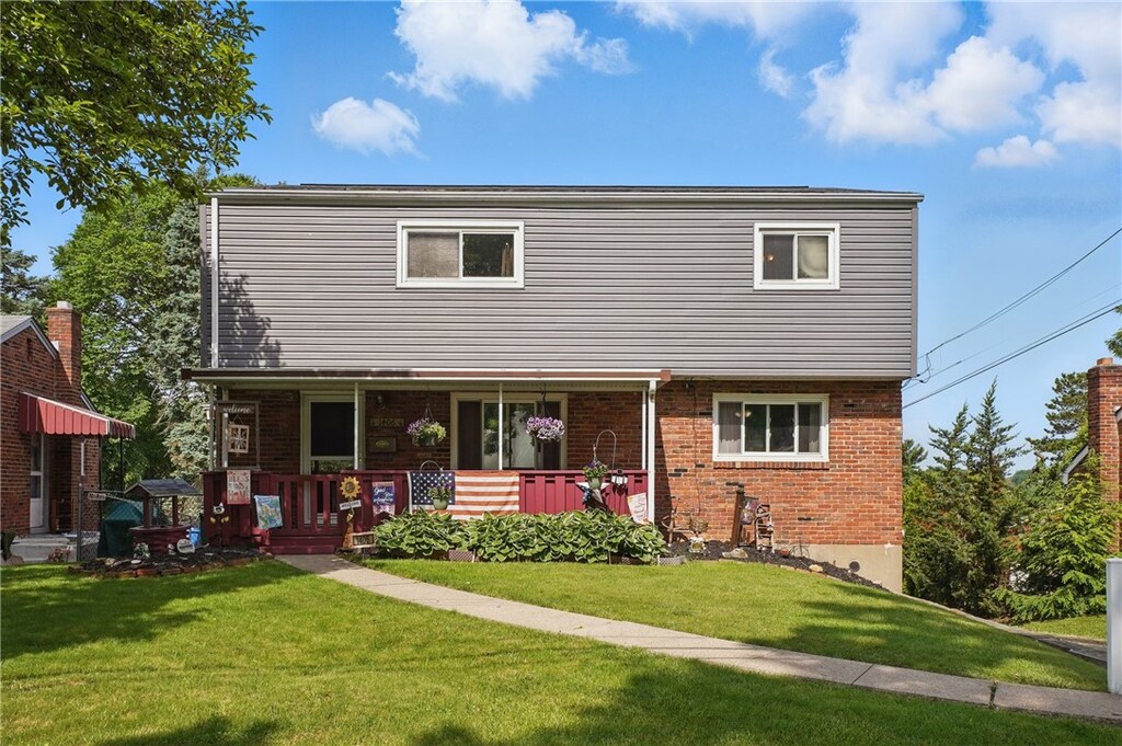 1406 Mccully Rd, Castle Shannon, PA 15234 - view of front of property featuring a front lawn, brick siding, and covered porch