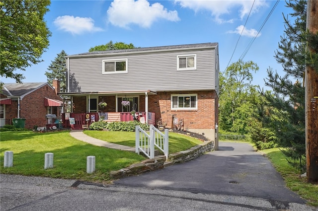 1406 Mccully Rd, Castle Shannon, PA 15234 - colonial house with a front yard, brick siding, and covered porch