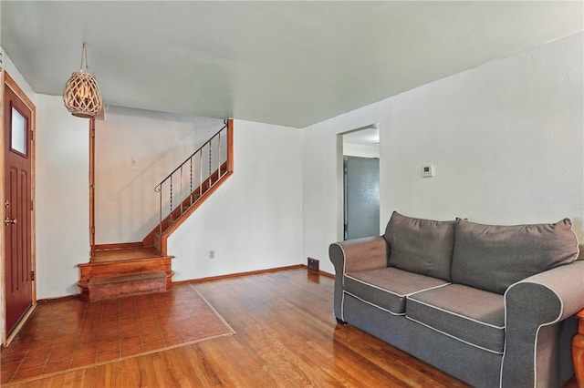 1406 Mccully Rd, Castle Shannon, PA 15234 - living area featuring wood finished floors, stairway, and baseboards