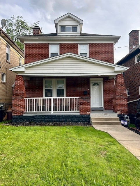 42 Queenston St, Overbrook, PA 15210 - american foursquare style home with brick siding, covered porch, and a front yard