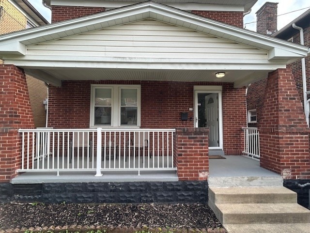 42 Queenston St, Overbrook, PA 15210 - view of exterior entry with a porch and brick siding