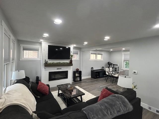 42 Queenston St, Overbrook, PA 15210 - living room featuring recessed lighting, wood finished floors, a large fireplace, and baseboards