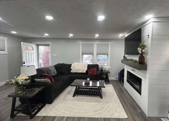 42 Queenston St, Overbrook, PA 15210 - living room featuring recessed lighting, baseboards, wood finished floors, and a glass covered fireplace