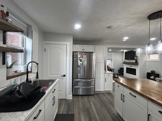 42 Queenston St, Overbrook, PA 15210 - kitchen featuring stainless steel refrigerator with ice dispenser, a sink, wood counters, a fireplace, and dark wood-style flooring