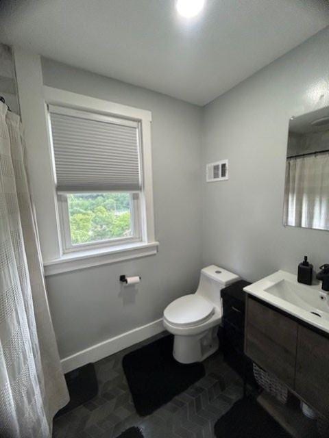 42 Queenston St, Overbrook, PA 15210 - bathroom featuring toilet, vanity, curtained shower, and baseboards