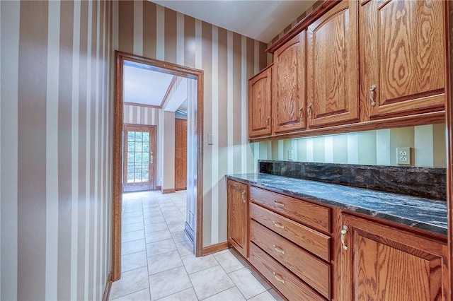 23 Pintail Dr, Indiana Twp Nal, PA 15238 - kitchen with wallpapered walls, light tile patterned floors, dark stone countertops, and brown cabinetry