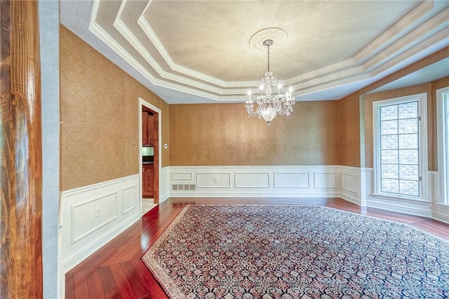 23 Pintail Dr, Indiana Twp Nal, PA 15238 - empty room featuring a chandelier, hardwood / wood-style floors, a raised ceiling, ornamental molding, and a wainscoted wall