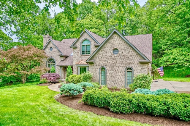 23 Pintail Dr, Indiana Twp Nal, PA 15238 - french country style house with a chimney, brick siding, a front yard, and a shingled roof