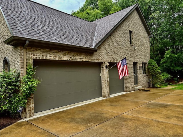23 Pintail Dr, Indiana Twp Nal, PA 15238 - view of home's exterior with brick siding, a shingled roof, an attached garage, and driveway