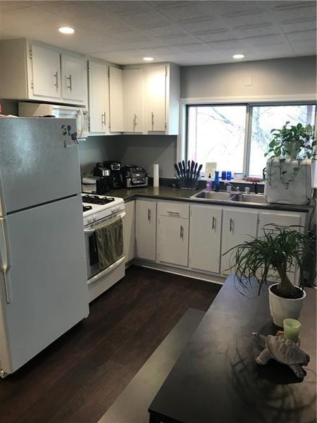 1322 Lowrie St, Troy Hill, PA 15212 - kitchen featuring white appliances, a sink, dark wood-style floors, dark countertops, and recessed lighting