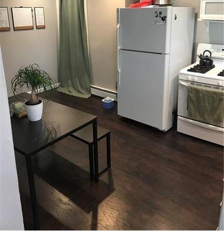 1322 Lowrie St, Troy Hill, PA 15212 - kitchen with white appliances, a baseboard heating unit, and dark wood-type flooring