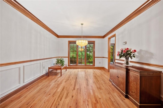15 Rosemont Ln, Squirrel Hill, PA 15217 - unfurnished dining area with a chandelier, light wood-style flooring, ornamental molding, wainscoting, and a decorative wall