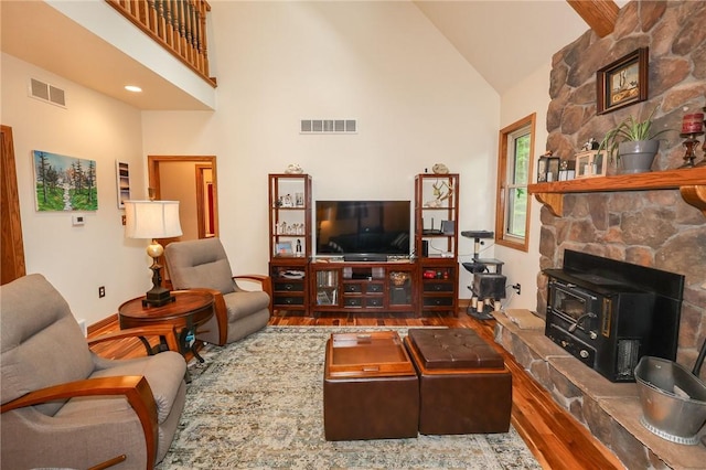 1147 Annisville Rd, Washington Twp But, PA 16050 - living area featuring a wood stove, wood finished floors, and high vaulted ceiling