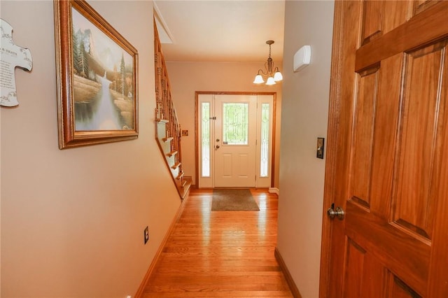 1147 Annisville Rd, Washington Twp But, PA 16050 - entrance foyer with light wood-type flooring, baseboards, a chandelier, and stairs
