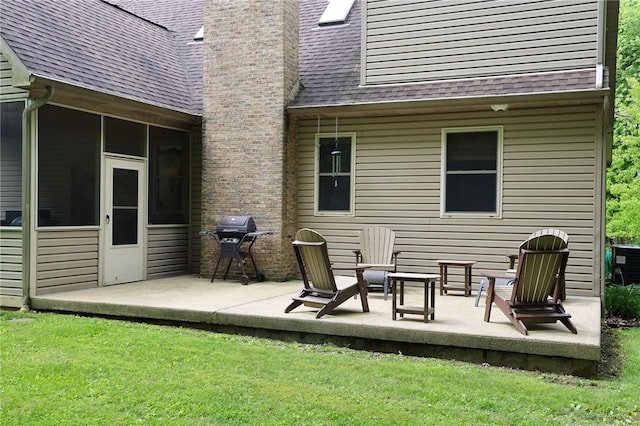 1147 Annisville Rd, Washington Twp But, PA 16050 - back of property with a patio area, roof with shingles, a chimney, a lawn, and a sunroom