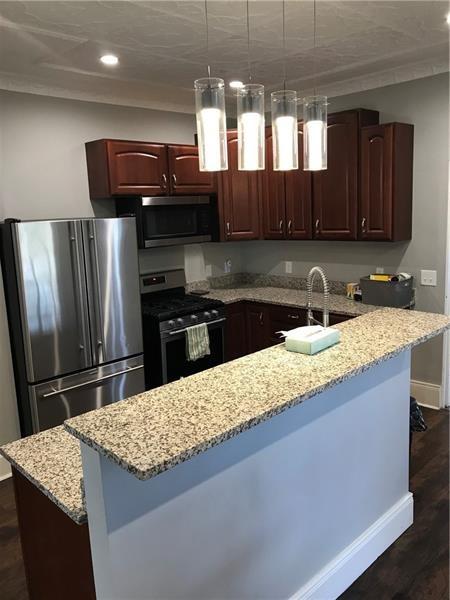 1124 Brabec St, Troy Hill, PA 15212 - kitchen with stainless steel appliances, baseboards, recessed lighting, a sink, and dark wood-style floors