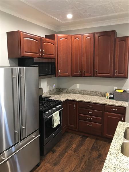 1124 Brabec St, Troy Hill, PA 15212 - kitchen featuring appliances with stainless steel finishes, dark wood-style flooring, light stone countertops, and recessed lighting