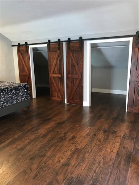 1124 Brabec St, Troy Hill, PA 15212 - bedroom featuring a barn door and dark wood-type flooring