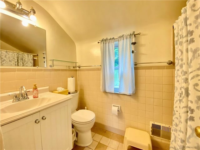 2220 Jacob St, Overbrook, PA 15234 - bathroom featuring tile walls, toilet, tile patterned floors, vanity, and lofted ceiling