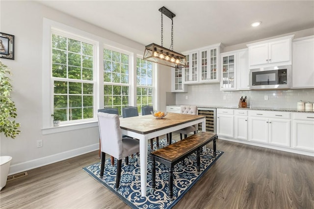 712 Mulkerrin Ct, Pine Twp Nal, PA 16046 - dining area with baseboards, plenty of natural light, dark wood-style flooring, wine cooler, and recessed lighting
