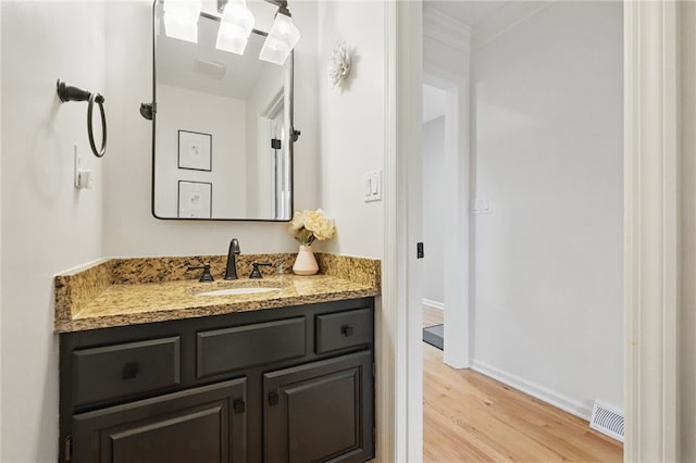 2455 Wedgewood Dr, Franklin Park, PA 15090 - bathroom with wood finished floors, vanity, baseboards, and crown molding