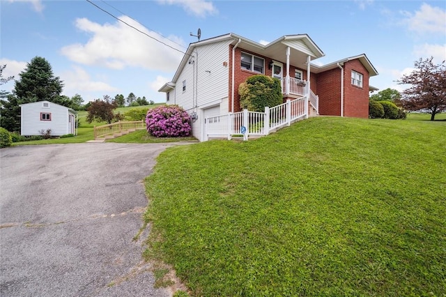 73 Hartman Rd, Green/Commdre/Prchse, PA 15759 - view of front of home featuring brick siding, driveway, an attached garage, a front yard, and an outbuilding
