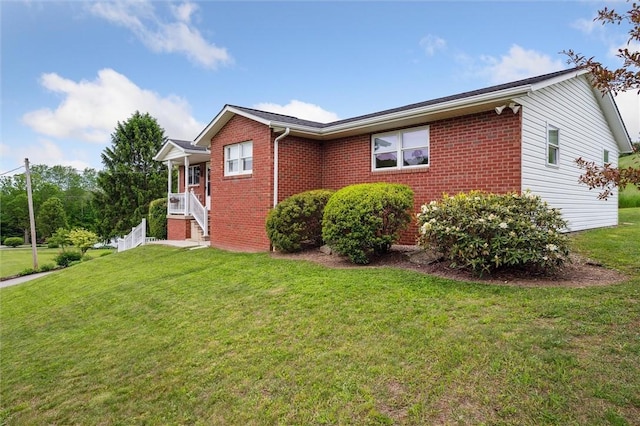 73 Hartman Rd, Green/Commdre/Prchse, PA 15759 - view of side of home featuring brick siding and a lawn