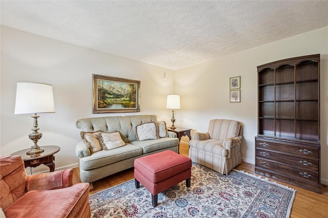 73 Hartman Rd, Green/Commdre/Prchse, PA 15759 - living room featuring wood finished floors, a textured ceiling, and baseboards